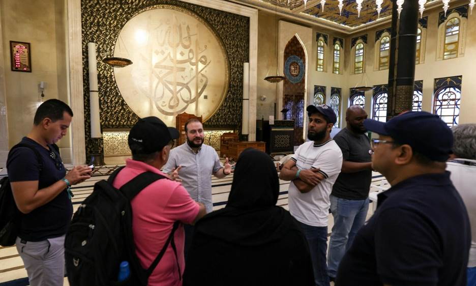 Football fans listen to a guide inside Doha’s Blue Mosque, during the Qatar 2022 World Cup football tournament, on November 29, 2022. — AFP