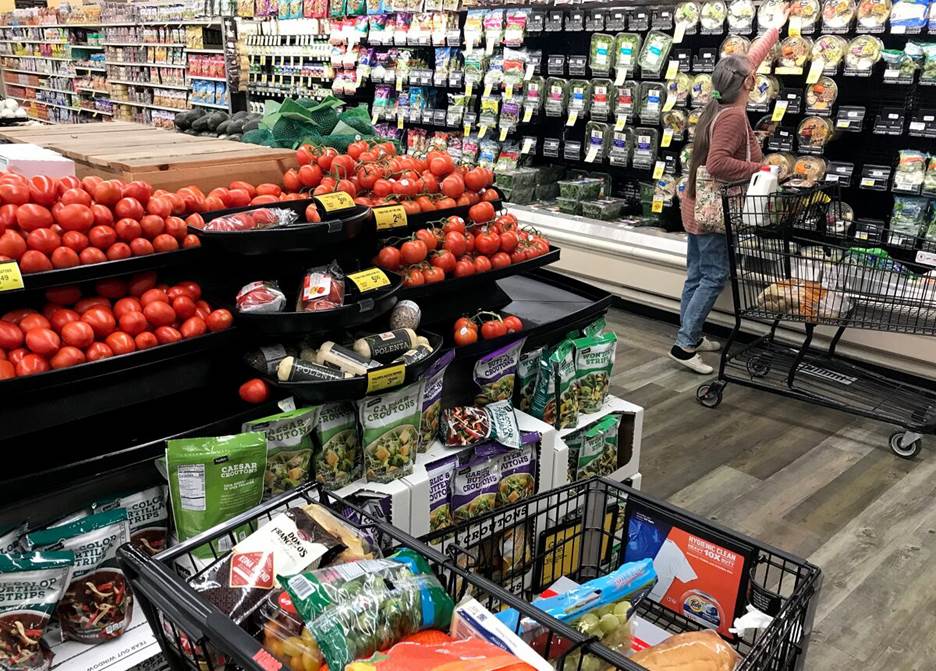 A shopper chooses produce in a Von's grocery store in Long Beach.