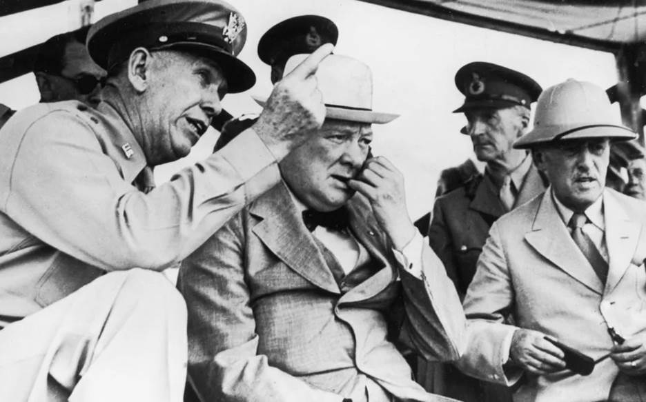 Henry Stimson (r) with Winston Churchill (c) and Gen George Marshall (l) review a US Army group in 1942 - Hulton Archive