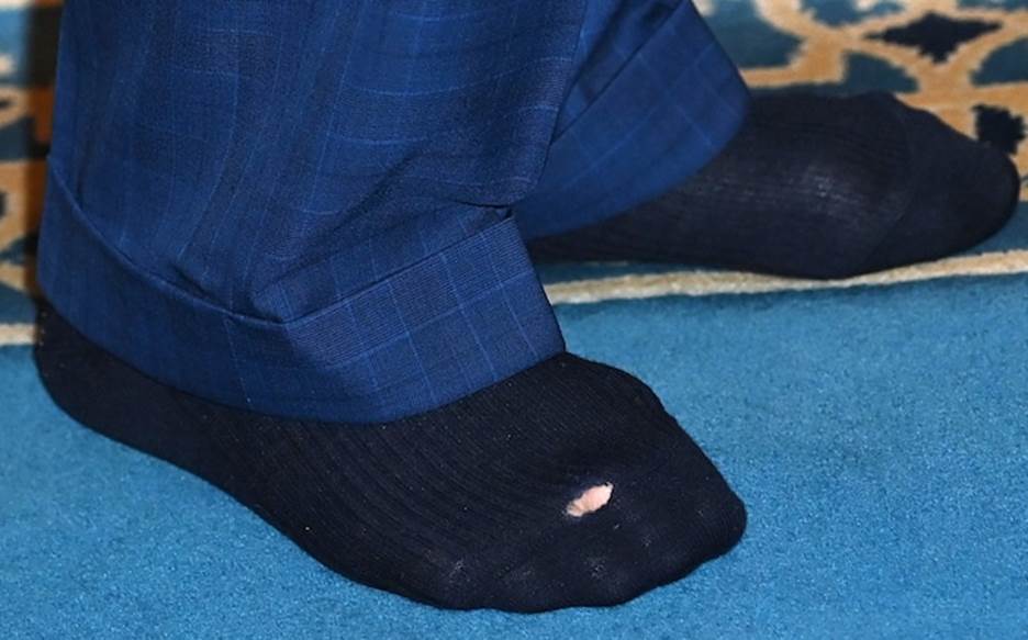 The socks of Britain's King Charles III are pictured during his visit Brick Lane Mosque