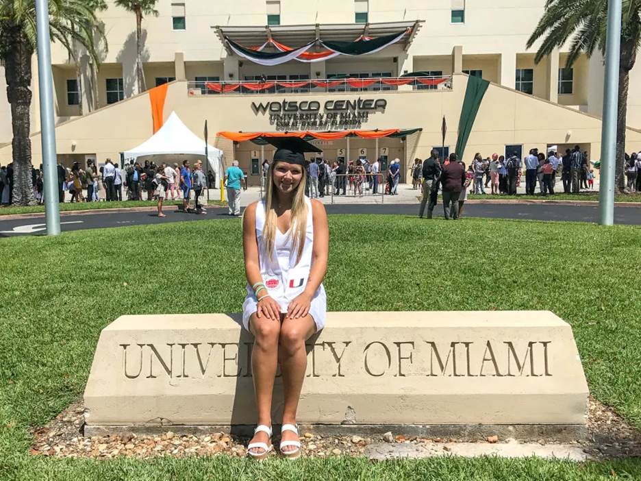Samantha Shea graduating from the university of Miami sat on the college's sign.