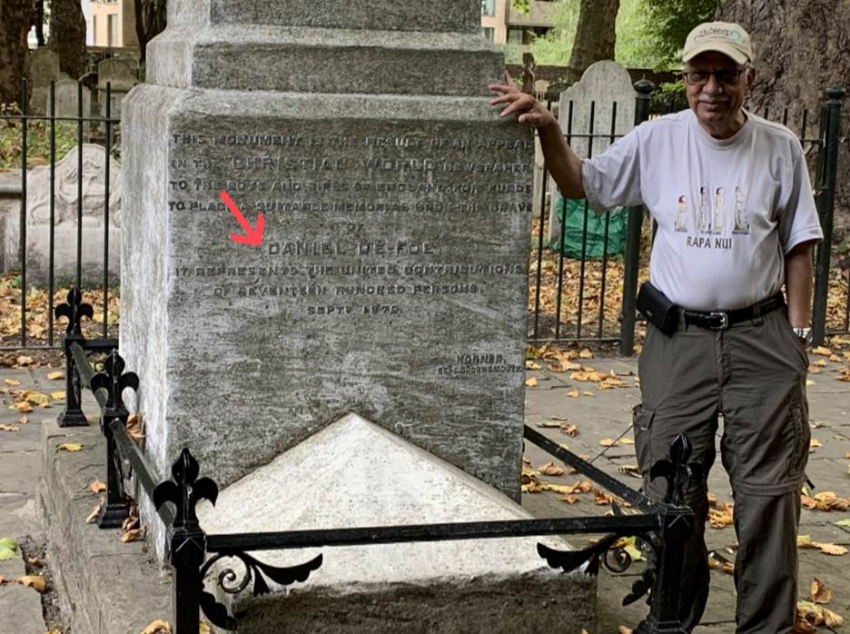 A person standing next to a monument  Description automatically generated