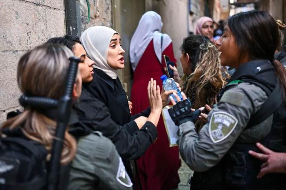 Muslim women argue with members of the Israeli security forces in the old city of Jerusalem as they arrive for the Friday noon prayer on October 13, 2023, amid the ongoing battles between Israel and the Palestinian Islamist group Hamas. (Photo by YURI CORTEZ / AFP) (Photo by YURI CORTEZ/AFP via Getty Images)