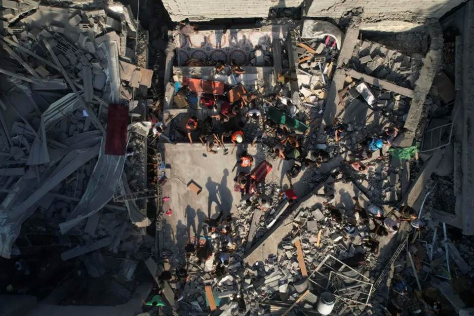 Palestinians inspect the rubble of buildings hit by an Israeli airstrike at Al Shati refugee camp.