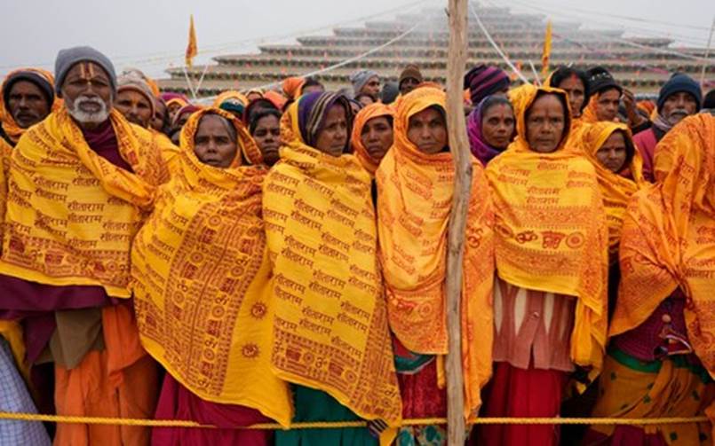A group of women wearing yellow scarves  Description automatically generated