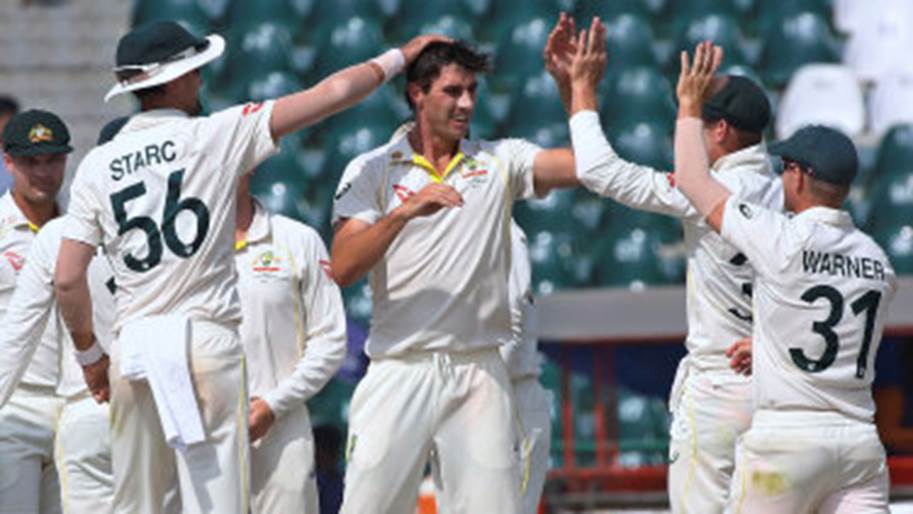 Australian captain Pat Cummins celebrates a Pakistan wicket with teammates on the final day of the third Test.