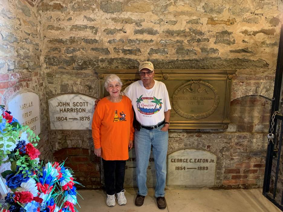 A person and person standing in front of a stone wall Description automatically generated with medium confidence