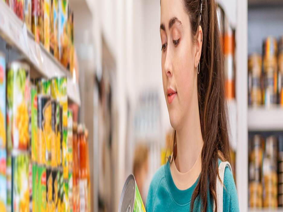 Person reading canned food label