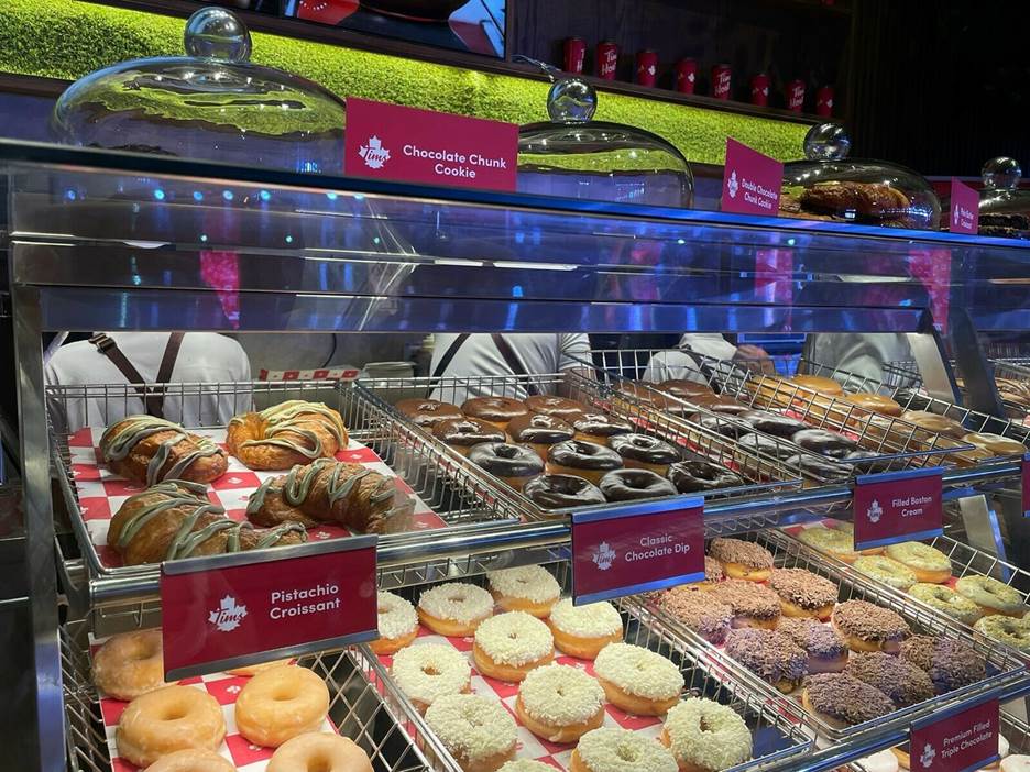 A picture containing text, indoor, case, pastry Description automatically generated