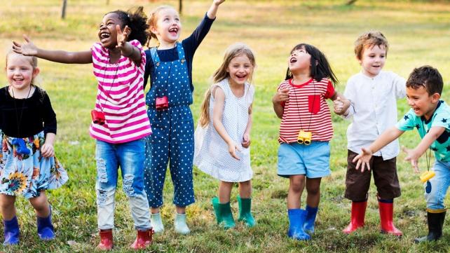 A group of children standing in a line  Description automatically generated with low confidence