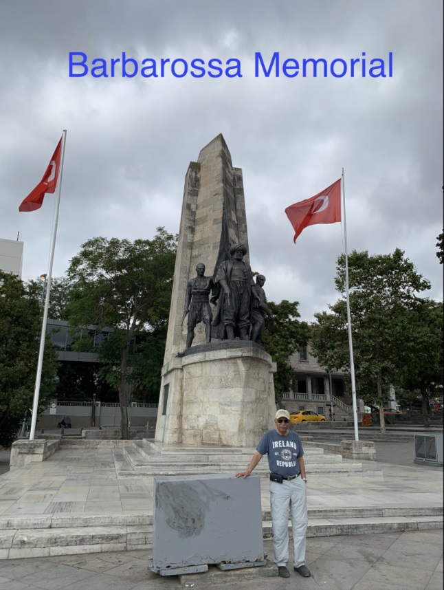 A person standing next to a statue Description automatically generated