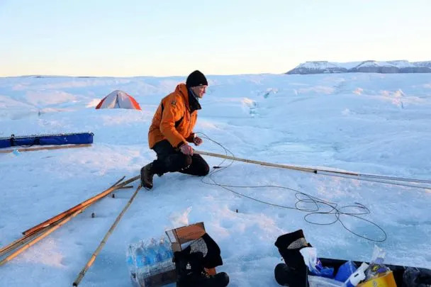 PHOTO: Keith Nicholls, a glaciologist from the British Antarctic Survey, works late in the evening on Petermann glacier on Aug. 27, 2016. (The Washington Post via Getty Images)