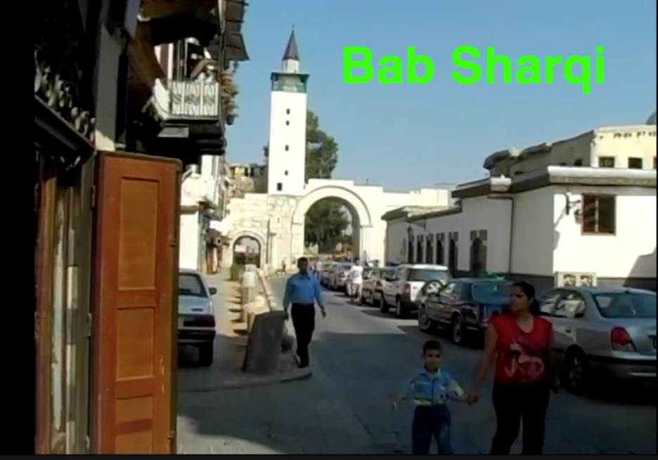 A person and child walking down a street Description automatically generated