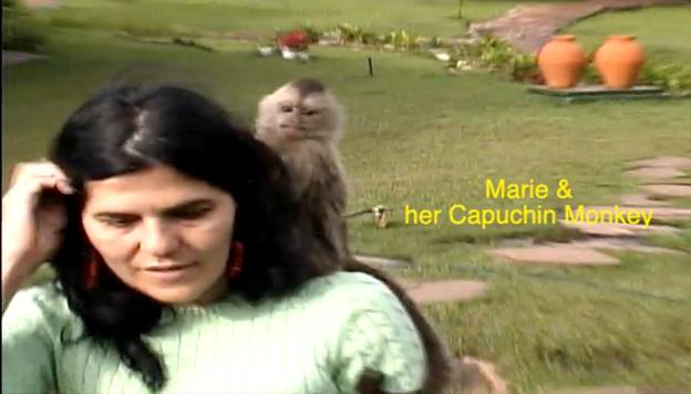 A person with a monkey on her back Description automatically generated
