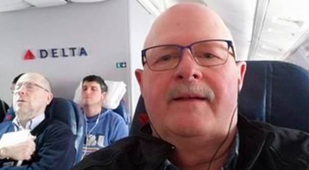 A person wearing glasses and a mustache Description automatically generated
