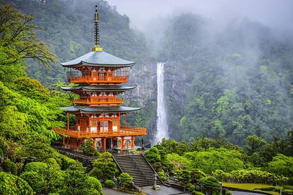 A building with a waterfall in the background Description automatically generated
