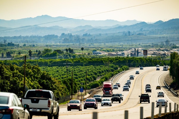 A highway with many cars and trees AI-generated content may be incorrect.