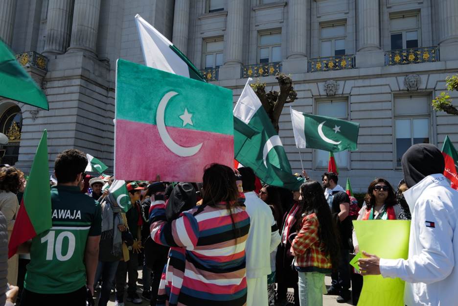 A group of people holding flags Description automatically generated with medium confidence