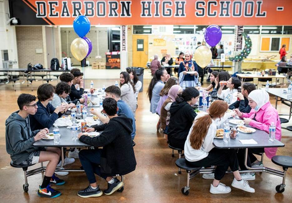 Dearborn High School students enjoy the iftar dinner with each other at Dearborn High School in Dearborn on Thursday, April 21, 2022.