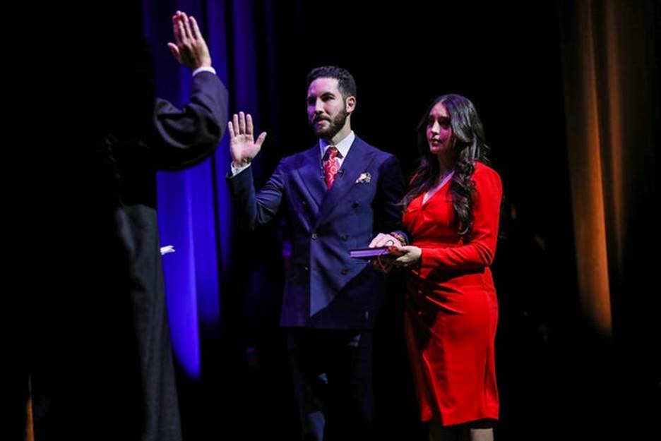 Mayor Abdullah Hammoud is sworn in as the new mayor of Dearborn by the 3rd Circuit Court Judge Helal Farhat, while his wife, Dr. Fatima Beydoun, holds the Quran for him to swear on at the Dearborn Performing Arts Center on Jan. 15, 2022. Hammoud is the first Arab American and first Muslim to be mayor of Dearborn.