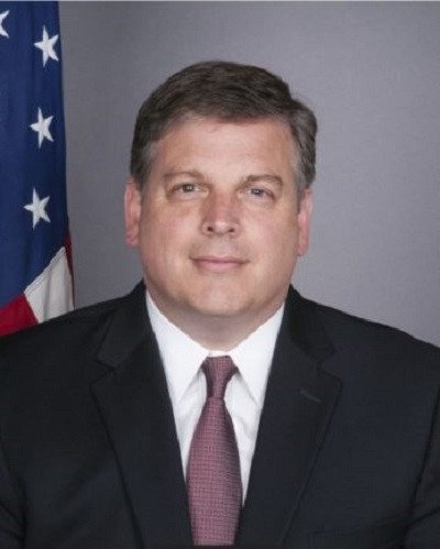 A person in a suit and tie Description automatically generated with medium confidence