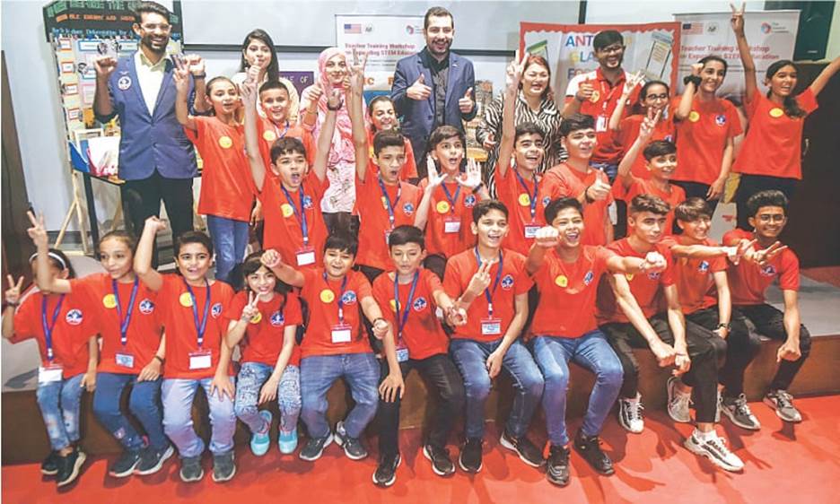 Students flash victory signs on stage at TDF MagnifiScience Centre after their talk with the media on Tuesday.—Fahim Siddiqi / White Star