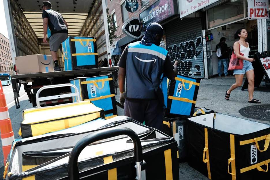 NEW YORK, NEW YORK - JULY 11: An Amazon worker moves boxes on Amazon Prime Day on July 11, 2023 in the East Village of New York City. Amazon holds the annual two-day event, where it offers shopping deals to Prime customers, in the middle of the summer. Amazon Prime Day has brought around 10 billion dollars to the company in each of the last 3 years, as customers look to take advantage of discounts and quick shipping. (Photo by Spencer Platt/Getty Images)