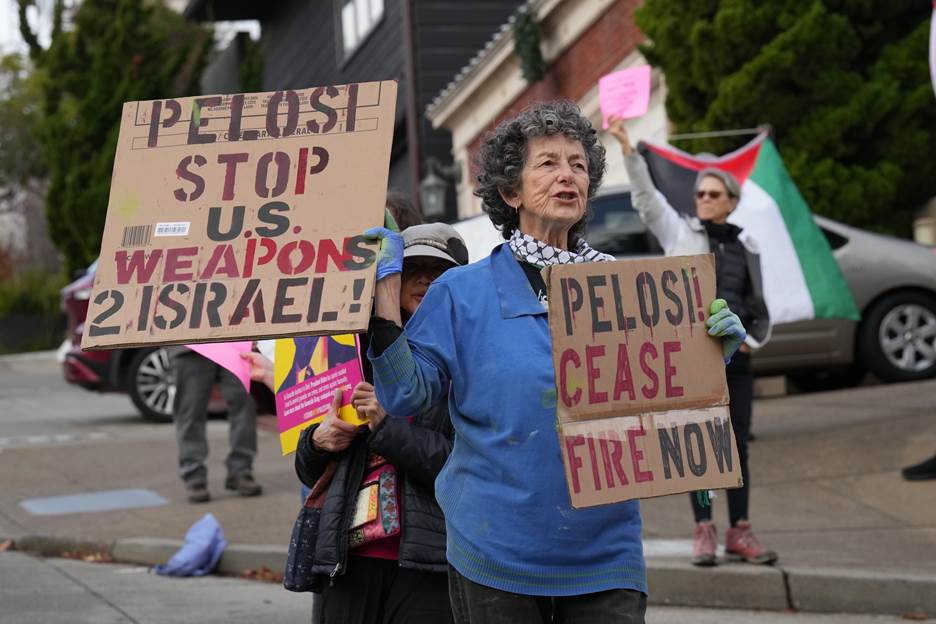 A group of people holding signs  Description automatically generated