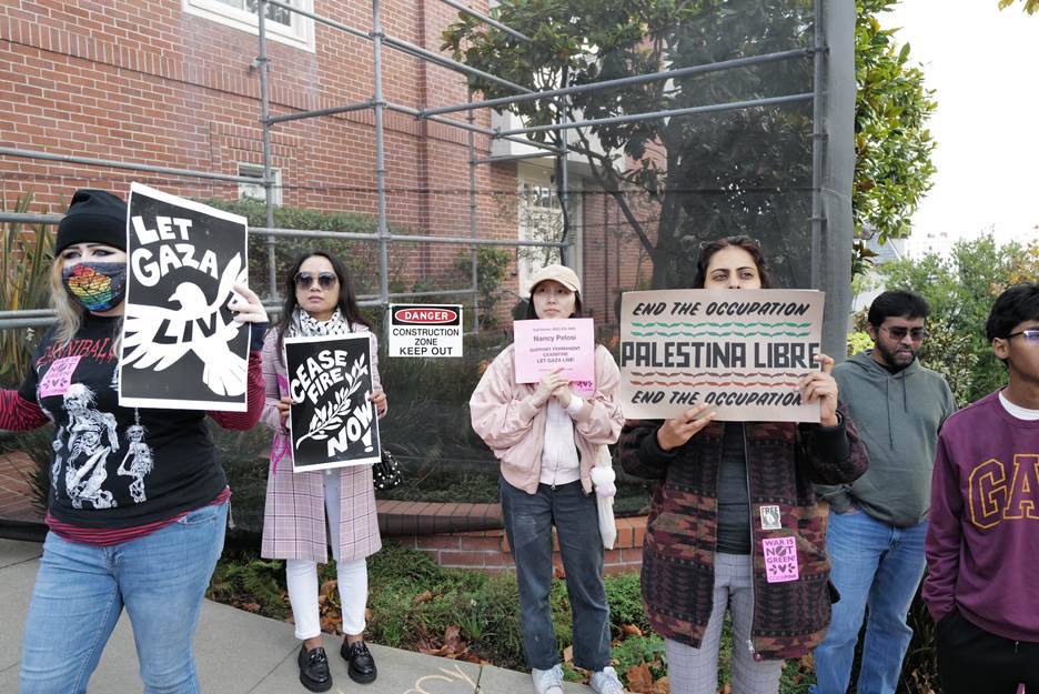 A group of people holding signs  Description automatically generated