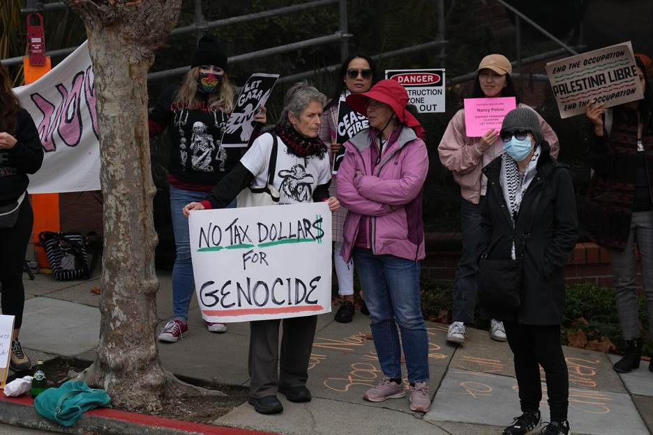 A group of people holding signs  Description automatically generated