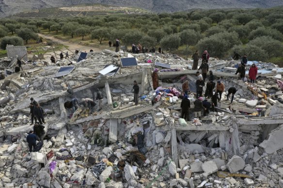 Syria’s opposition Civil Defence workers and residents search through the rubble of collapsed buildings in the town of Harem near the Turkish border, Idlib province, on Monday.