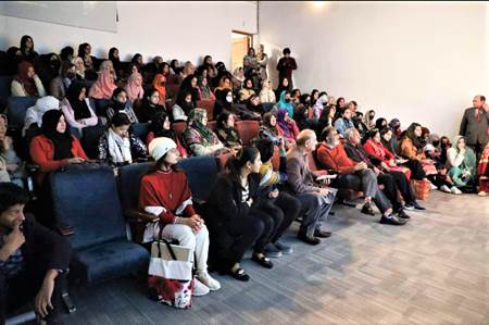 A group of people sitting in chairs  Description automatically generated with medium confidence