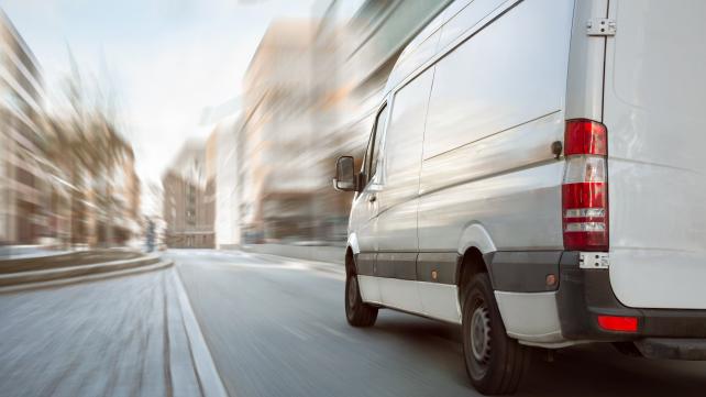 A white truck on a road Description automatically generated with low confidence