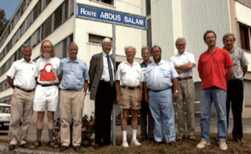 A group of men standing in front of a building  Description automatically generated
