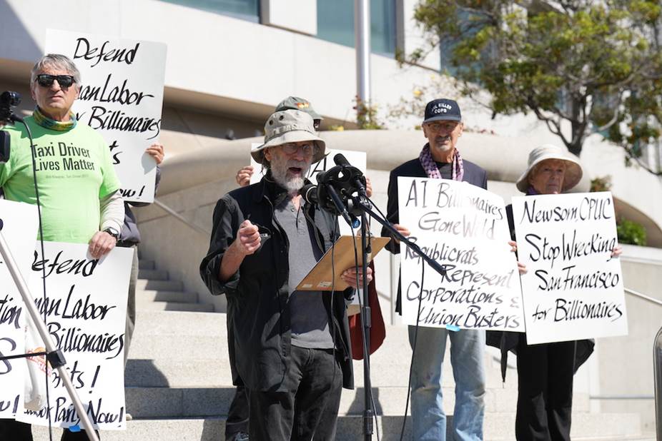 A group of people holding signs  Description automatically generated