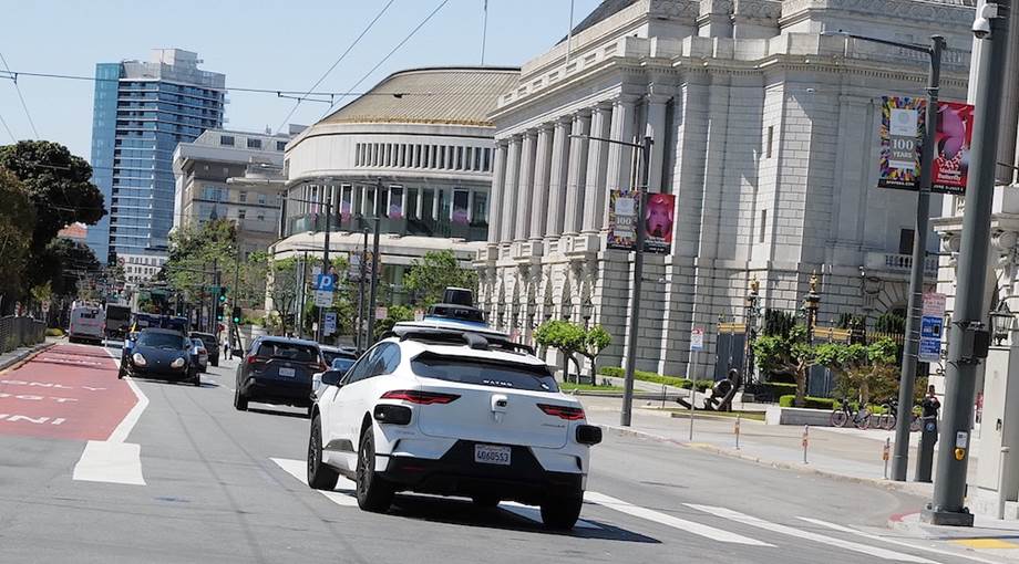 A white car on the street  Description automatically generated