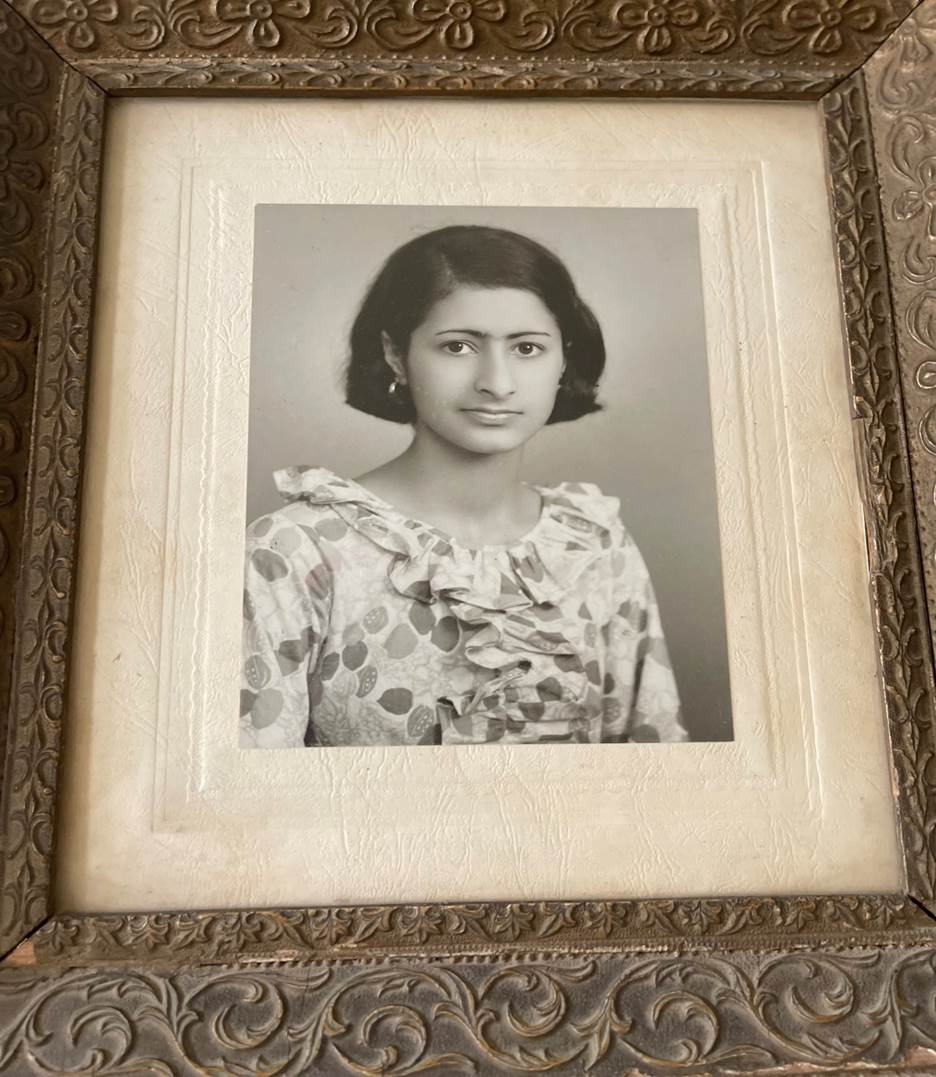 A framed picture of a person Description automatically generated