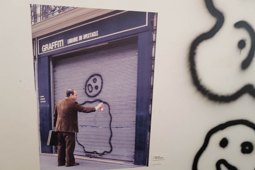 A person drawing a face on a garage door Description automatically generated with low confidence