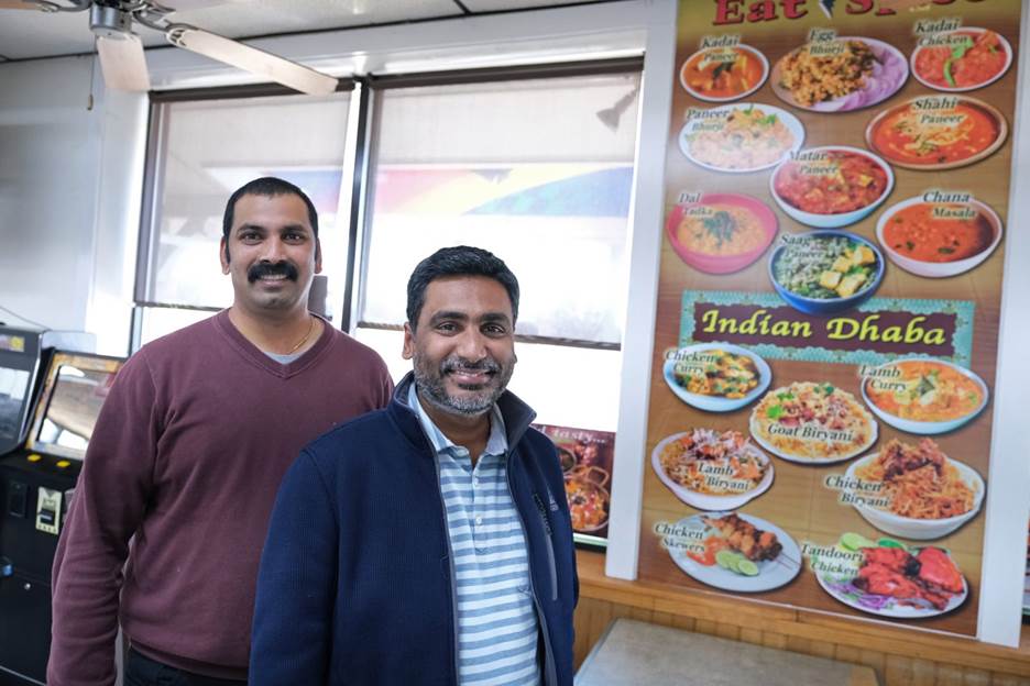 Co-owners Vamsi Yaramaka, left, and Raj Alturu, right, stand inside Eat Spice on Oct. 24, 2019, in the truck stop on route 534 off I-80 in White Haven, Pennsylvania. The restaurant caters to members of the Sikh community and as there is a large population of truckers from that community, the Indian Dhaba and Mediterranean dishes become hard to find on the road.