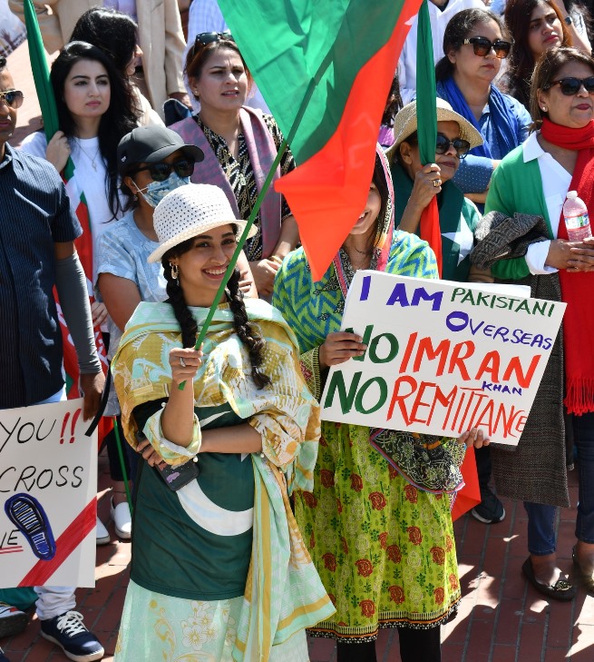 A group of people holding signs Description automatically generated