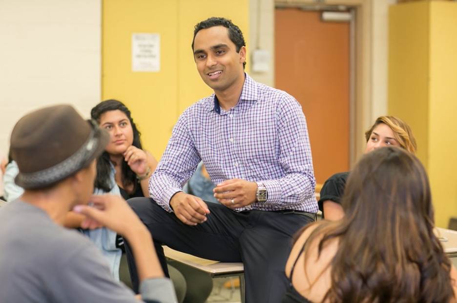 A person sitting in a circle with a group of people  Description automatically generated with medium confidence