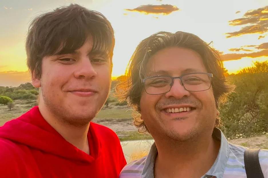 Two men taking a selfie  Description automatically generated with medium confidence