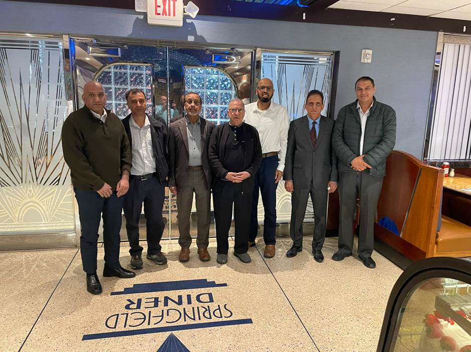 A group of men standing in front of a glass door Description automatically generated with medium confidence
