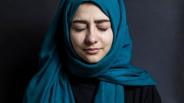 A person wearing a blue hoodie Description automatically generated with low confidence