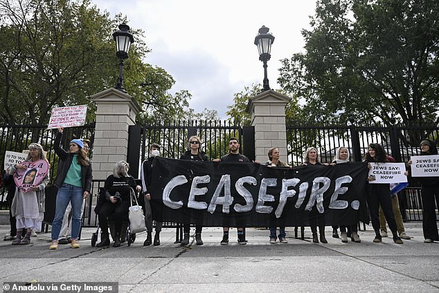 A group of people holding a banner Description automatically generated