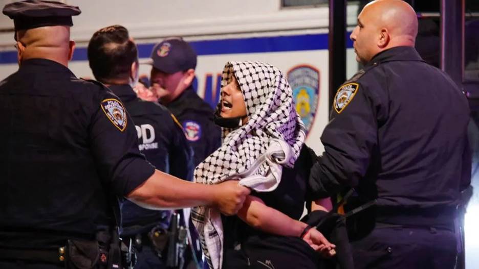 A woman is arrested by police officers after protesters clashed with members of the New York Police Department at a rally in support of Palestinians in Brooklyn on October 21, 2023. - Kena Betancur/AFP/Getty Images