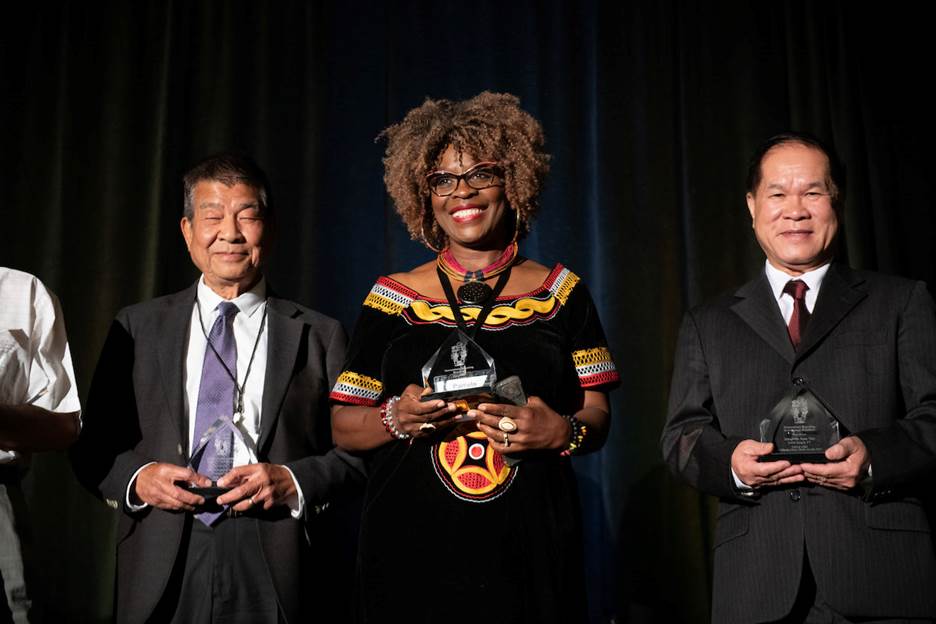 Medium shot of people holding awards Description automatically generated