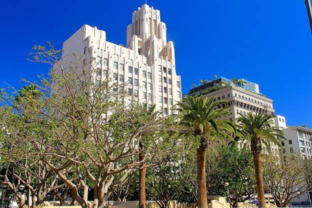 A tall building with trees in front of it Description automatically generated