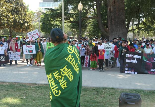 A group of people protesting Description automatically generated