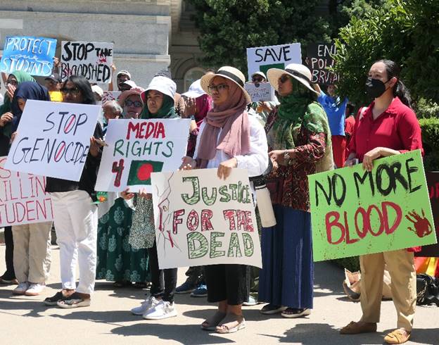 A group of people holding signs Description automatically generated
